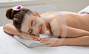 Closeup of calm young woman enjoying sea salt massage