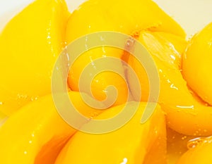 Closeup canned peach halves in syrup