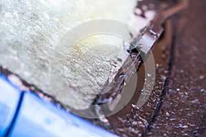 Closeup of a car covered in snow