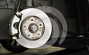 Closeup car disk brake maintenance service in car garage and copy spcae