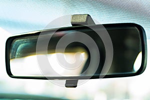 Blurred rear view mirror of modern car close up