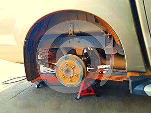 Closeup of a car rim without a tire jacking up for raising the axle of a motor vehicle off the ground so that a wheel can be chang