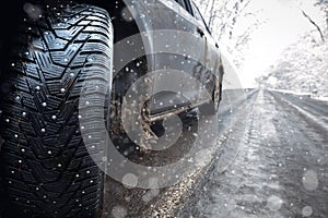 Closeup of car spikes  tires in winter on the road