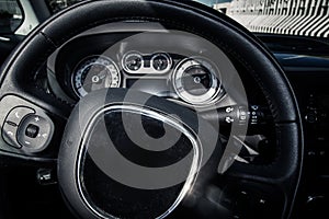 Closeup of car steering wheel and dashboard