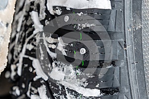 Closeup of car tires in winter covered with snow