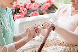 Closeup of a caring volunteer working in a retirement home holdi