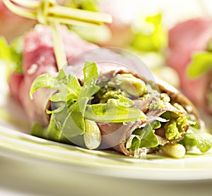 Closeup of carpaccio rolls with pesto