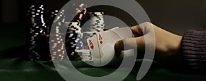 Closeup. Casino chips and playing cards in the player`s hand.