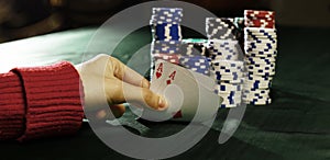 Closeup. casino chips and playing cards in the player`s hand.