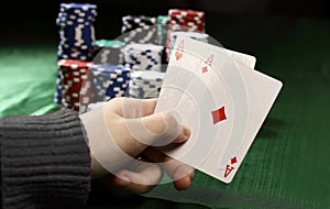 Closeup. casino chips and playing cards in the player`s hand.