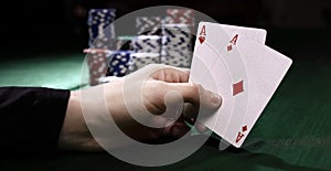 Closeup. casino chips and playing cards in the player`s hand.