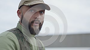 Closeup of a Caucasian hunter commenting on something