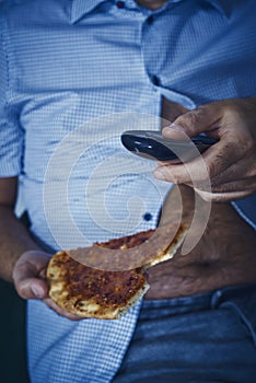 Man with a beer belly eating pizza photo