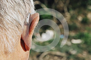 Senior man wearing a hearing aid photo