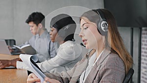 Closeup caucasian young business woman call center help line operator salesperson wears headset speaks advises client