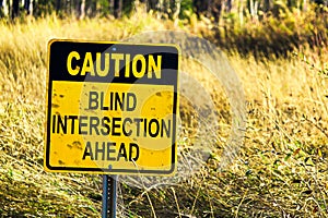 Closeup of a Caution Blind Intersection Ahead sign