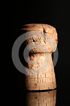 Closeup of champange cork on black background with reflection