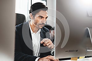 Closeup of cheerful businessman working at loft office.Man using contemporary desktop computer.Horizontal.Blurred