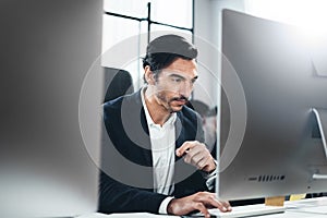 Closeup of cheerful businessman working at loft office.Man using contemporary desktop computer.Horizontal.Blurred