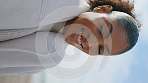 Closeup cheerful woman laughing at autumn beach vertical. Happy curly girl relax