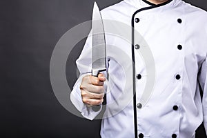 Closeup of a chef holding a big sharp knife