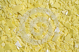 Closeup chemical ingredient on laboratory table Top View. Sodium sulfide flakes, a yellow appearance owing to the presence of