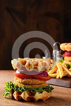 Closeup chicken burger waffle sandwich on wood table