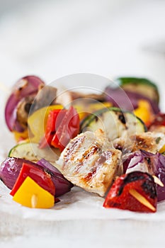 Closeup of chicken skewers or shashlik with grilled vegetables