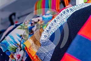 Closeup of child boy clothes hanging in a closet, showing shirts and sweaters