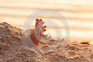 Closeup child kid feet on white sand beach.