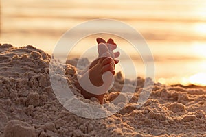 Closeup child kid feet on white sand beach.