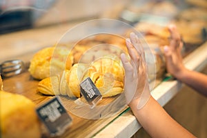 Closeup of child's hands on glass wanting to