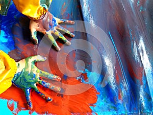 Closeup of children hands painting during a school activity - learning by doing, education and art, art therapy concept