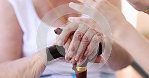 Closeup of children hands touching hands of elderly and woman