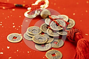 Closeup of Chinese copper coins on the red background, talisman amulet for money
