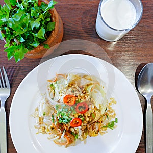 Closeup of chinese food, Fried noodle mixed with egg and vegetables on white plate