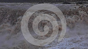 Closeup of Chinese Yellow River waterfall, turbulent flowing river, slow motion