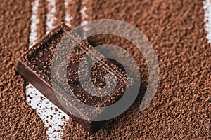 Closeup chocolate bar and cocoa powder on white background