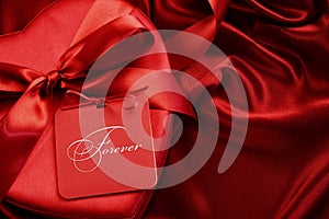 Closeup chocolate box with gift card on satin