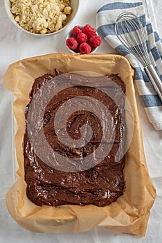 Closeup of chocolate cake with raspberry and streusel