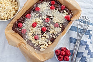 Closeup of chocolate cake with raspberry and streusel