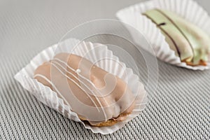 Closeup of chocolate eclair on grey background