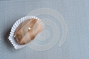 Closeup of chocolate eclair on grey background