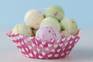 Closeup of chocolate speckled Easter eggs in cupcake liner.