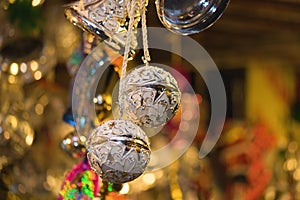 Closeup of Christmas holiday tree decorations with bokeh on background