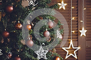 Closeup on christmastree with ornaments and stars