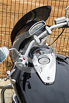 Closeup of chrome black motorcycle parked