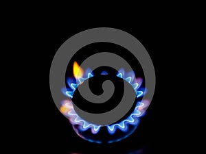 Closeup of circular burner blue and yellow flame