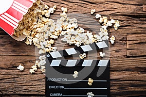 Clapperboard And Popcorn On Wood Representing Movie Time