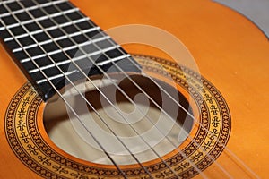 Closeup of classic acoustic guitar strings and fret board